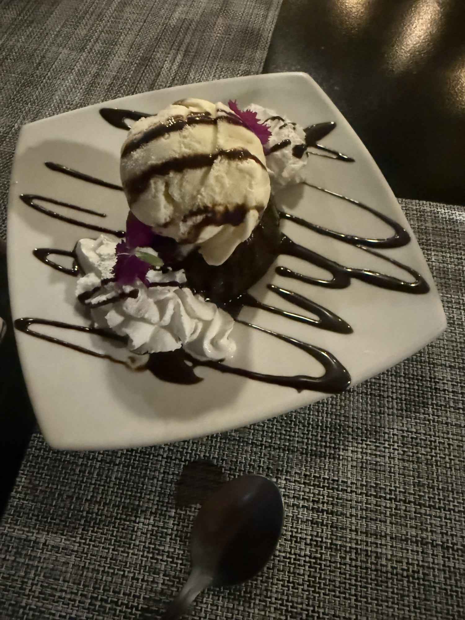Chocolate dessert with ice cream and edible flowers